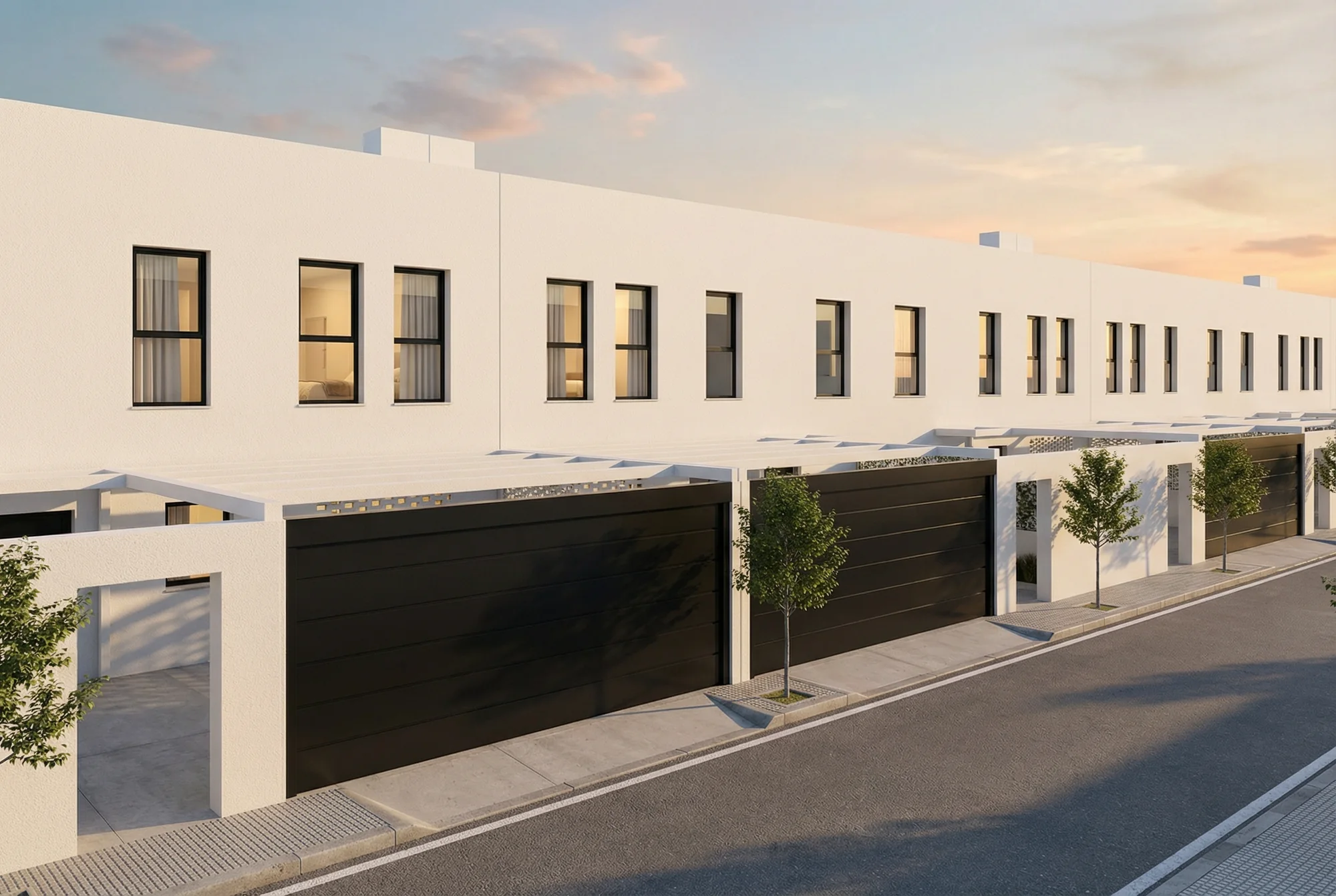 Fachada urbana de una promoción residencial blanca con accesos y arbolado